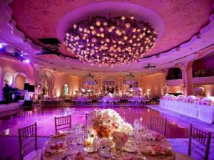 Lighting in pink and purple colors with aesthetically decorated banquet hall. 