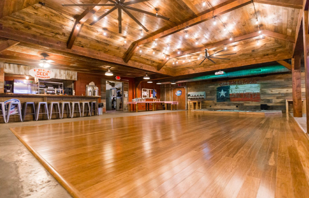 A wooden dance floor arranged for a party at a banquet hall.