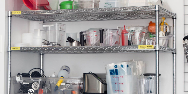 An open kitchen rack with items arranged in it